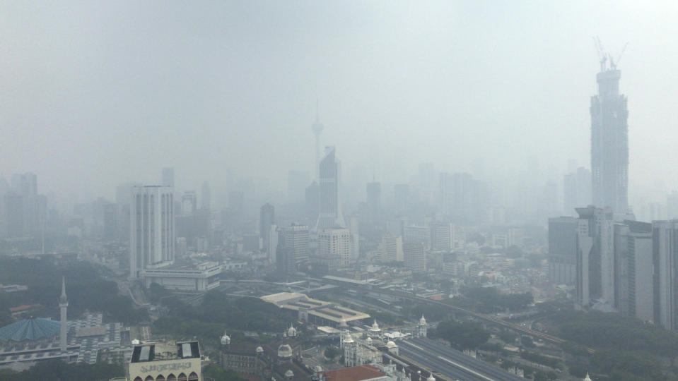 Kuala Lumpur city is shrouded with haze in Kuala Lumpur, Malaysia, Sunday, Sept. 15, 2019. Malaysia's government has banned open burning and conducted cloud-seeding in Sarawak on Thursday to induce rain to clear the choking haze. (AP Photo)