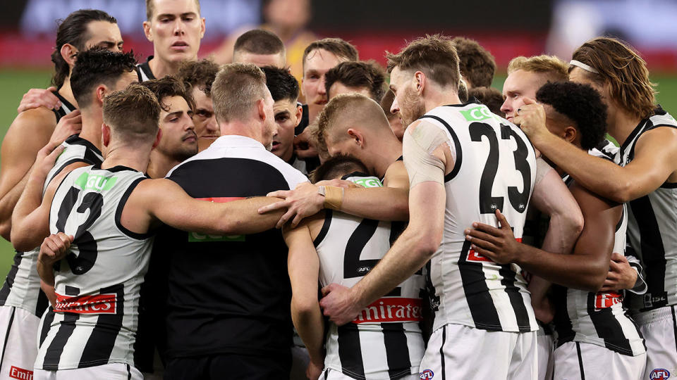 Seen here, Collingwood's AFL team gathers in a huddle during the 2020 AFL finals series.