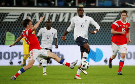 Soccer Football - International Friendly - Russia vs France - Saint-Petersburg Stadium, Saint Petersburg, Russia - March 27, 2018 France’s Paul Pogba in action with Russia’s Aleksandr Golovin REUTERS/Grigory Dukor