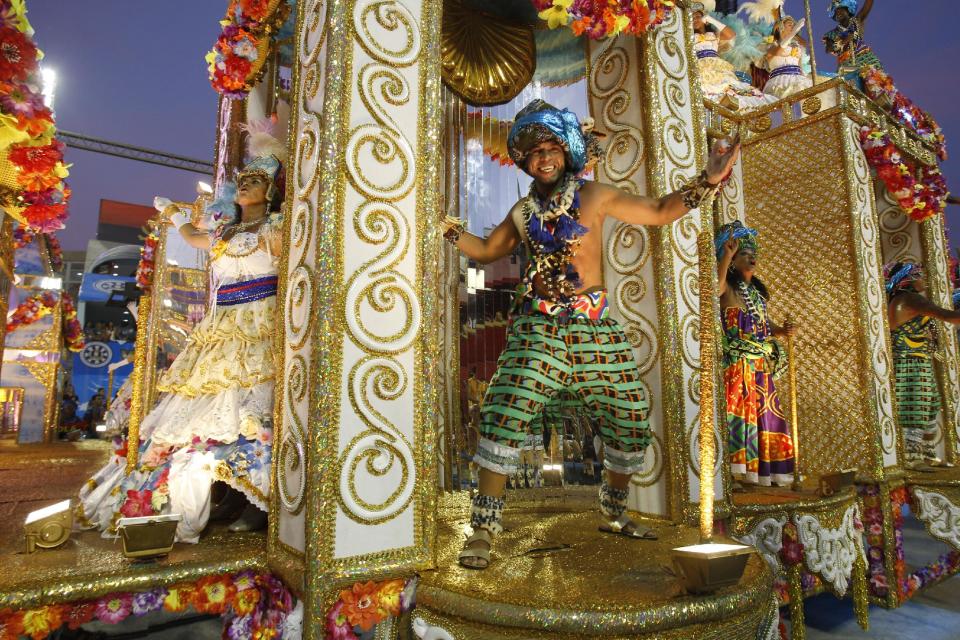 Performers from the Unidos da Vila Isabel samba school parade during carnival celebrations at the Sambadrome in Rio de Janeiro, Brazil, Monday, Feb.20, 2012.   Millions watched the sequin-clad samba dancers at Rio de Janeiro's iconic Carnival parade.  (AP Photo/Victor R. Caivano)