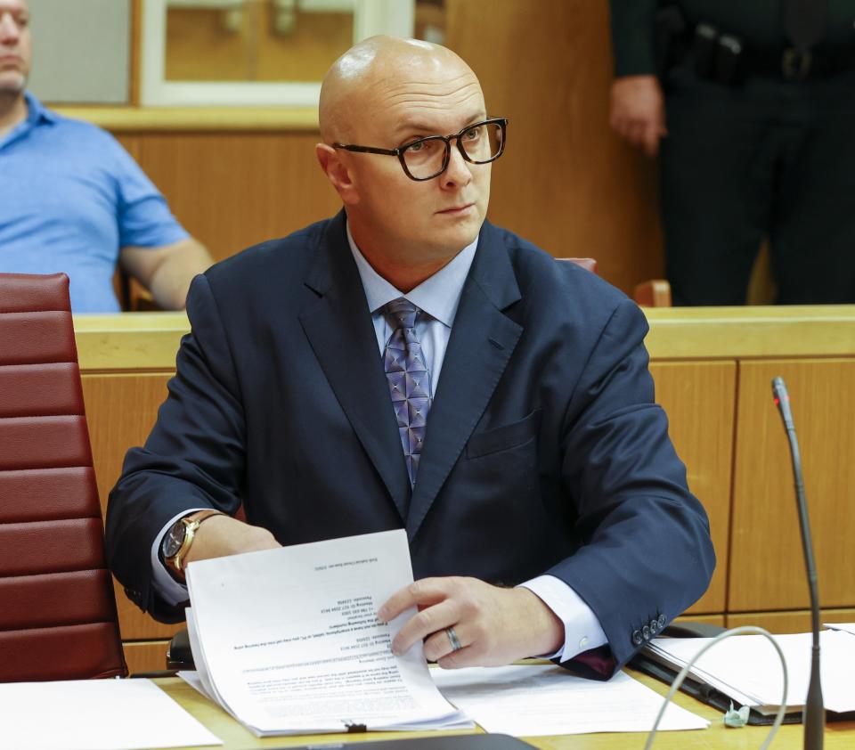 FILE- In this June 22, 2021, file photo, William Braddock looks through papers during a hearing, Tuesday, in Clearwater, Fla. Anna Paulina Luna, who plans to run for Florida's District 13 seat after losing a race for the slot in 2020 to Democratic U.S. Rep. Charlie Crist, contends in court documents that GOP challenger William Braddock is stalking her and wants her dead. (Chris Urso/Tampa Bay Times via AP, File)