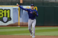 Texas Rangers shortstop Corey Seager throws to first base for an out against Oakland Athletics' Tyler Nevin during the first inning of a baseball game Monday, May 6, 2024, in Oakland, Calif. (AP Photo/Godofredo A. Vásquez)