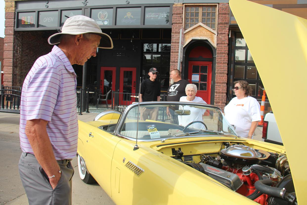 Don Stracke, of Perry, checks out Jean Sheffer's 1956 Thunderbird as Sheffer chats with Diane Lansman during the PerryDice Cruizers Car Show on Saturday, Oct. 9, 2021, in Perry.