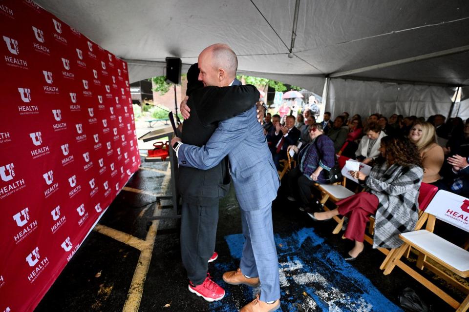 Adolphus Nickelberry receives a hug from Gov. Spencer Cox during a program and ribbon-cutting to celebrate the University of Utah Health’s new Rose Park Population Health Center on Thursday. Nickelberry is a patient at the center.