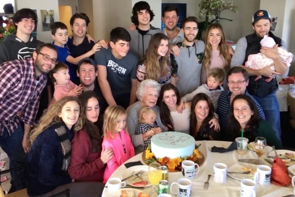 June Patinkin is surrounded by her dozens of grandchildren and great-grandchildren at a family gathering.