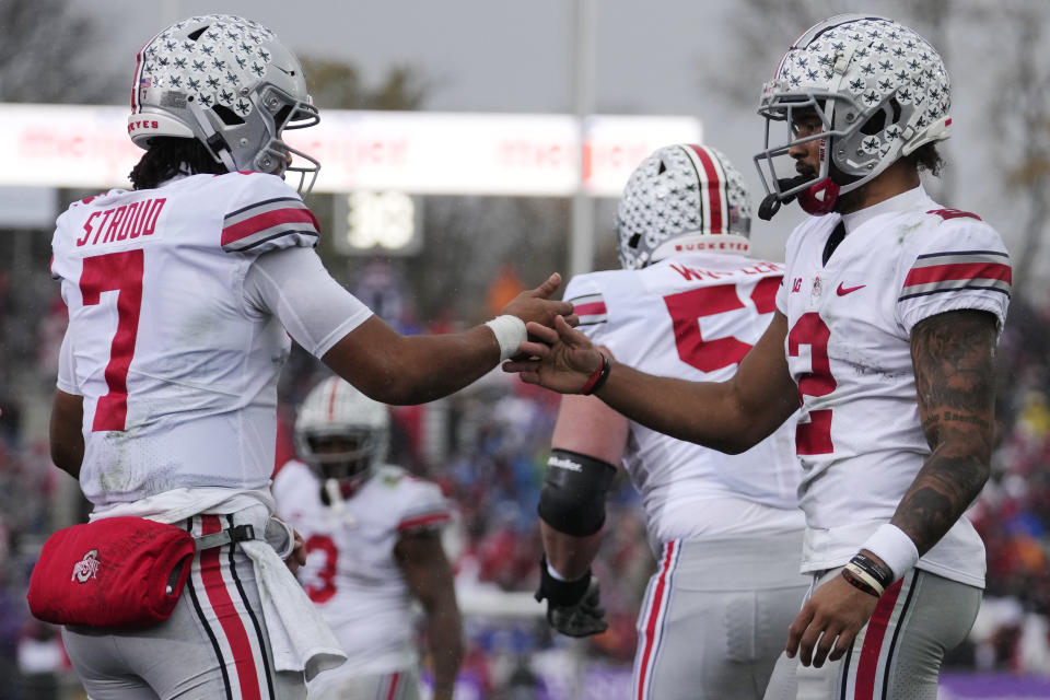 Ohio State wide receiver Emeka Egbuka, right, celebrates with quarterback C.J. Stroud after scoring a touchdown against Northwestern during the first half of an NCAA college football game, Saturday, Nov. 5, 2022, in Evanston, Ill. (AP Photo/Nam Y. Huh)