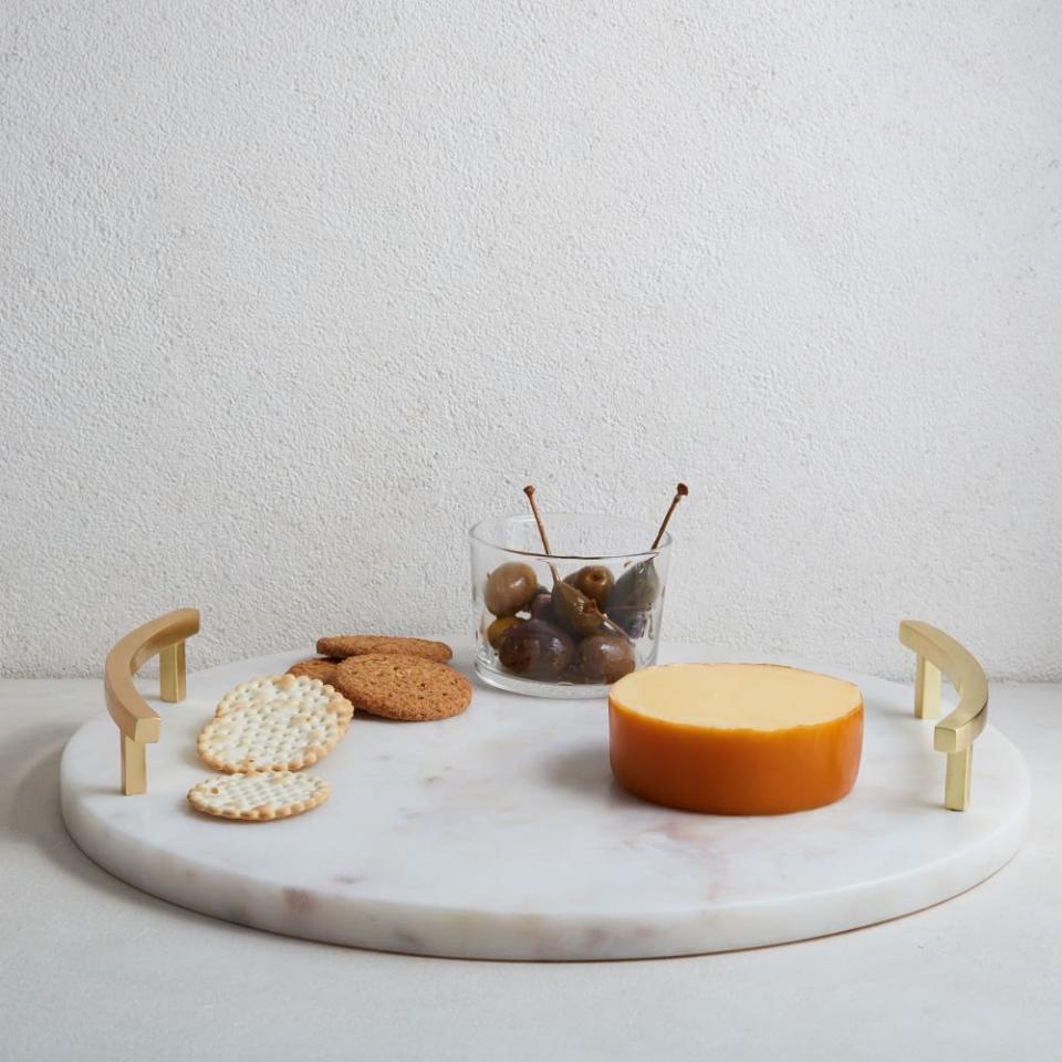 <p><a href="https://go.redirectingat.com?id=74968X1596630&url=https%3A%2F%2Fwww.westelm.com%2Fproducts%2Fmarble-brass-round-cheese-board-e1736%2F%3FcatalogId%3D71%26sku%3D3049236%26cm_ven%3DPLA%26cm_cat%3DGoogle%26cm_pla%3DKitchen%2B%2526%2BDining%2B%253E%2BCharcuterie%2BBoards%2B%2526%2BKnives%26region_id%3D669950%26cm_ite%3D3049236%26gclid%3DCjwKCAjwiY6MBhBqEiwARFSCPiK0nEPhKPauaTY7KuZI6yKcCY3-iiwDjw70MfWwRIA6XHjFPMGSxRoCXxYQAvD_BwE&sref=https%3A%2F%2Fwww.thepioneerwoman.com%2Fhome-lifestyle%2Fentertaining%2Fg32293314%2Fhostess-gifts-ideas%2F" rel="nofollow noopener" target="_blank" data-ylk="slk:Shop Now;elm:context_link;itc:0;sec:content-canvas" class="link ">Shop Now</a></p><p>Marble and Brass Round Serving Board</p><p>westelm.com</p><p>$48.00</p><span class="copyright">West Elm </span>