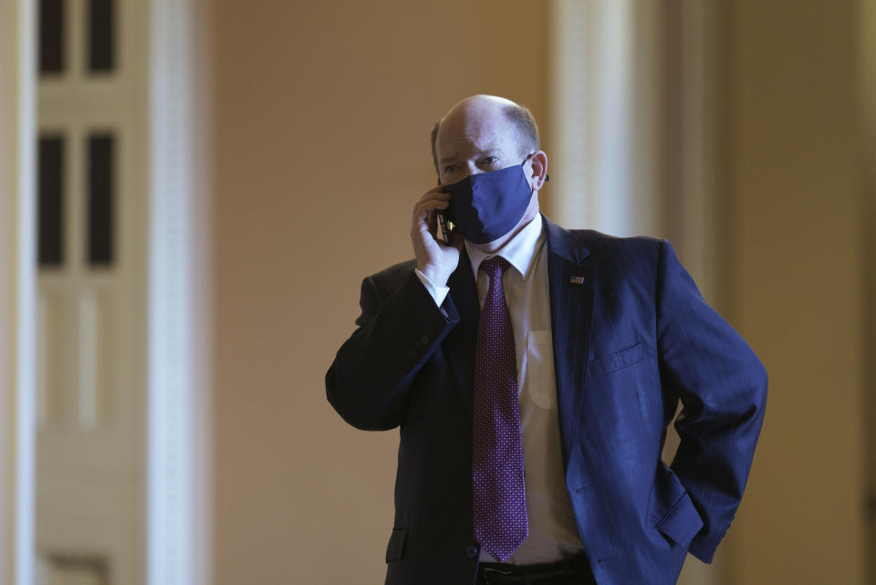 Sen. Chris Coons, D-Del., a friend and ally of President Joe Biden, speaks on his phone outside the chamber before passage of the Democrat's $1.9 trillion COVID-19 relief bill, at the Capitol in Washington, Saturday, March 6, 2021. Senate passage sets up final congressional approval by the House next week so lawmakers can send it to President Joe Biden for his signature. (AP Photo/J. Scott Applewhite)