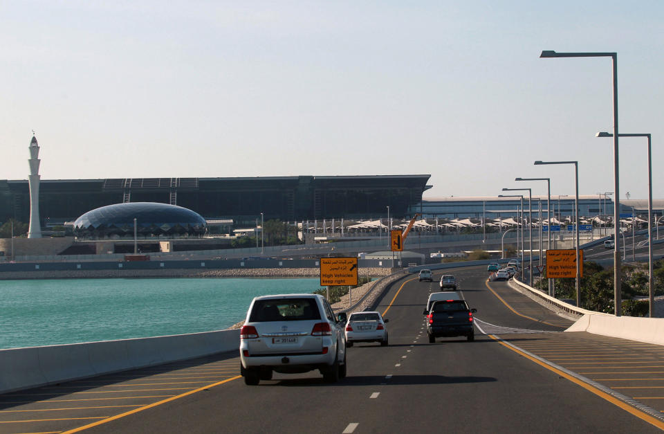 Cars drive on road leading to Hamad International Airport