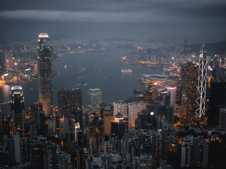 A bird's eye view of a sprawling bay-side cityscape.