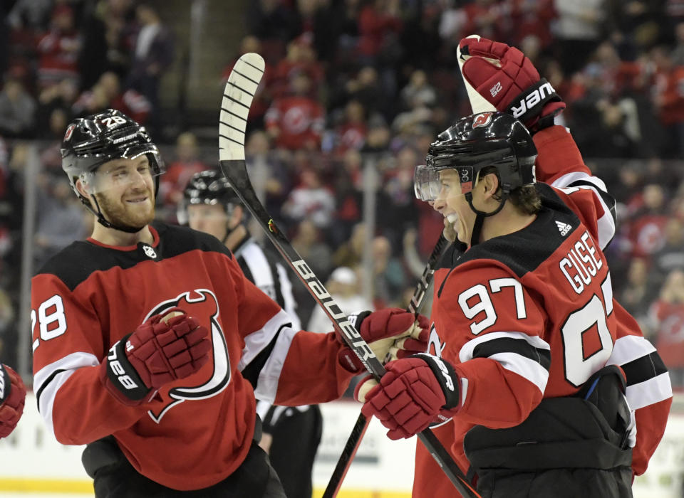 New Jersey Devils left wing Nikita Gusev (97) celebrates his goal with defenseman Damon Severson (28) during the second period of an NHL hockey game against the Los Angeles Kings, Saturday, Feb. 8, 2020, in Newark, N.J. (AP Photo/Bill Kostroun)