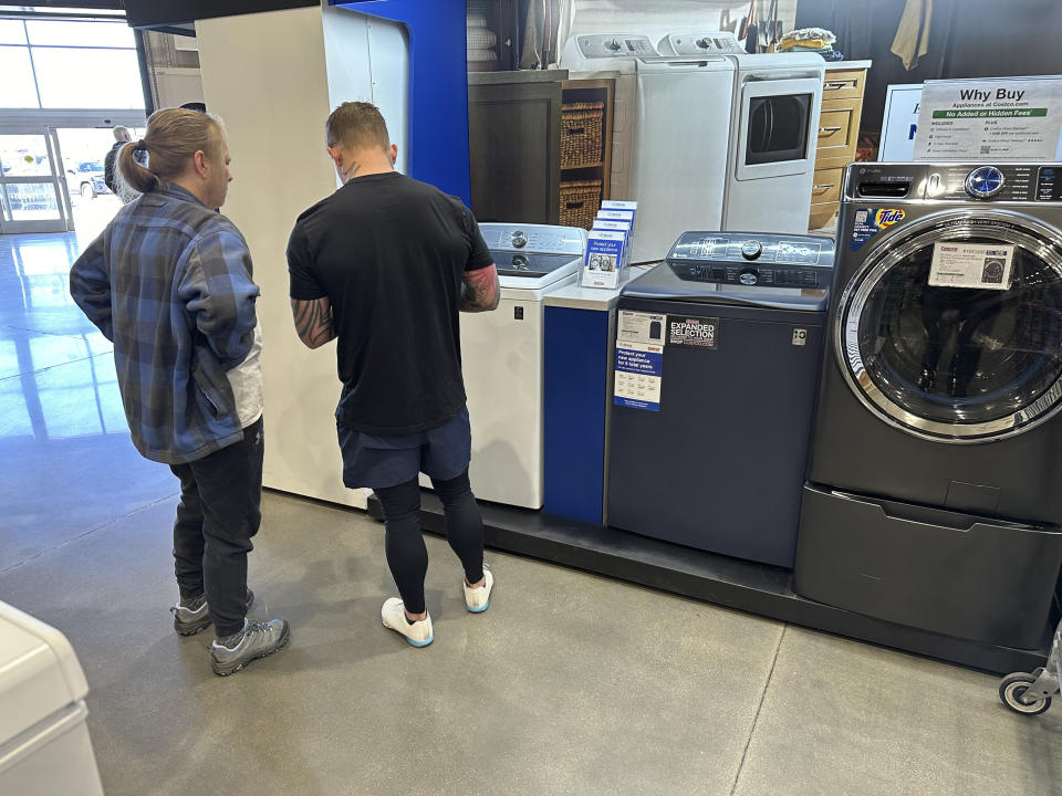 FILE - Shoppers consider appliances on display in a Costco warehouse March 6, 2024, in Sheridan, Colo. On Friday, May 31, 2024, the Commerce Department issues its report on consumer spending for April. (AP Photo/David Zalubowski, File)