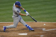 Los Angeles Dodgers' Austin Barnes (15) singles on a ground ball to Los Angeles Angels second baseman David Fletcher during the fourth inning of a baseball game Saturday, May 8, 2021, in Anaheim, Calif. Chris Taylor scored. (AP Photo/Ashley Landis)