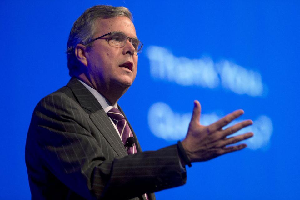 FILE - This Jan. 29, 2014 file photo shows former Florida Gov. Jeb Bush speaking in Hollywood, Fla. Bush said Thursday the partisan divide isn’t as wide when it comes to improving the nation’s higher education system as it is in many other areas. Hillary Rodham Clinton, who like Bush is often mentioned as a potential 2016 president candidate, accepted Bush’s invitation to appear at a conference he is co-hosting on global higher education issues. It begins Monday in Irving, Texas. (AP Photo/Wilfredo Lee, File)