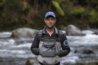 Adam Daniel stands for a portrait in the upper reaches of the Whanganui River in New Zealand on June 16, 2022. Daniel monitors the Whanganui and dozens of other rivers for Fish & Game New Zealand. He has found more sediment even in the river's upper reaches than in nearby waterways. Forestry, four-wheel-drive trails and other human impacts are factors, but near the Whanganui's source, Daniel points out where a power company is sucking out water as part of the Tongariro Power Scheme. (AP Photo/Brett Phibbs)