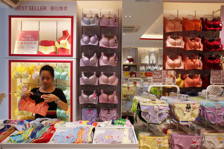 A sales representative works at Cosmo Lady lingerie store in the southern Chinese city of Shenzhen, China July 15, 2016. Picture taken July 15, 2016. REUTERS/Bobby Yip