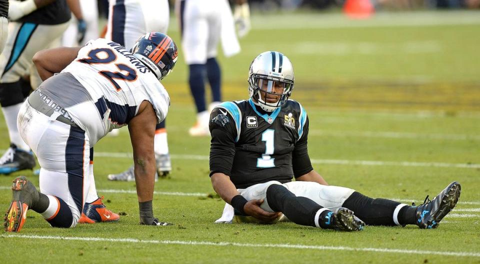 Carolina Panthers quarterback Cam Newton, right, is slow to get up after being knocked to the turf by Denver’s Sylvester Williams at Super Bowl 50. The Denver Broncos defeated the Carolina Panthers 24-10, as Newton was sacked six times and harassed many more.