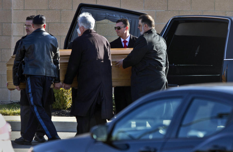 FILE - In this Dec. 18, 2013 file photo, the casket of Dustin Friedland is carried into a temple for a funeral service in Lakewood, N.J. Four men charged in the fatal carjacking of the young lawyer at an upscale New Jersey mall just before Christmas were due in court Wednesday, Jan. 8, 2014, for arraignment. (AP Photo/The Asbury Park Press, Doug Hood) NO SALES