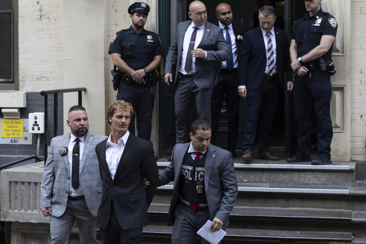 Daniel Penny, center, is walked by New York Police Department detectives detectives out of the 5th Precinct on Friday, May. 12, 2023 in New York. Manhattan prosecutors announced Thursday they would bring the criminal charge against Penny, 24, a U.S. Marine Corps veteran, in the May 1 death of 30-year-old Jordan Neely. (AP Photo/Jeenah Moon)