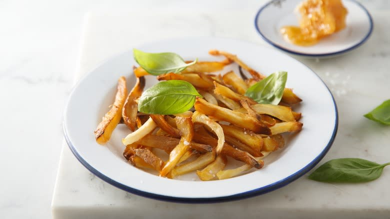 parsnip fries on white plate 