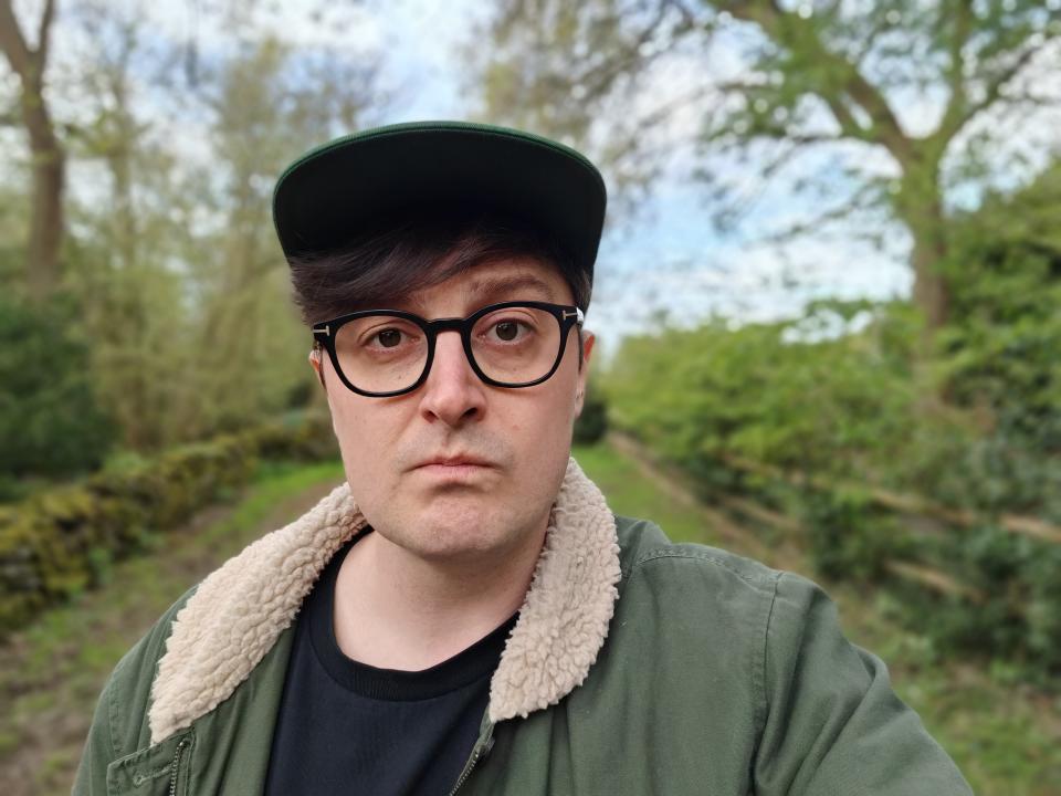 Selfie of a man outside surrounded by trees