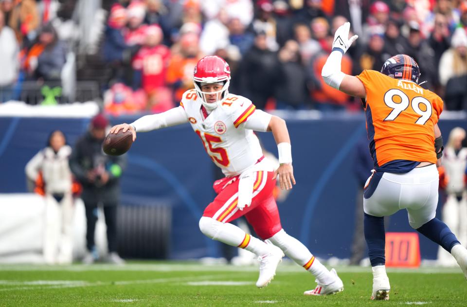 Oct 29, 2023; Denver, Colorado, USA; Kansas City Chiefs quarterback Patrick Mahomes (15) scrambles away from Denver Broncos defensive end Zach Allen (99) in the first quarter at Empower Field at Mile High. Mandatory Credit: Ron Chenoy-USA TODAY Sports