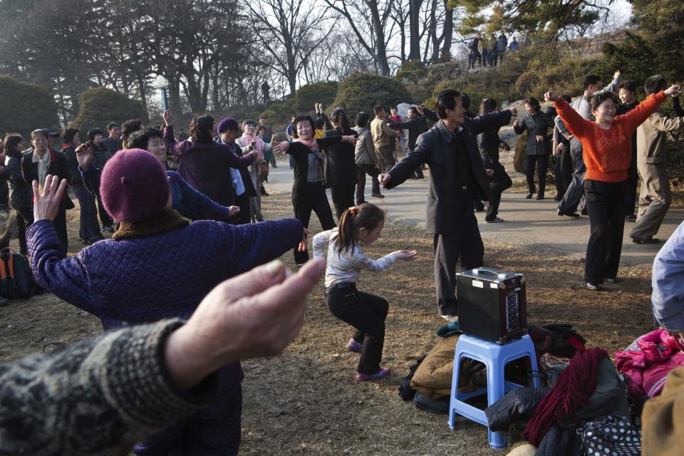 In this March 8, 2013 photo, North Koreans gather in a park in Pyongyang to dance to popular local music played on a speaker. A funding crunch for aid to North Korea has become so severe 500,000 rural schoolchildren are as of April 2014, no longer receiving assistance and aid to millions more could soon dry up, according to a report obtained by The Associated Press. The report underscores the flight of international donors to countries with less political baggage and more willingness to let aid workers do their jobs. (AP Photo/David Guttenfelder)