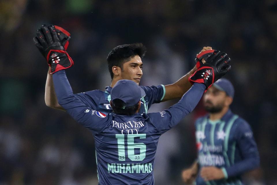 Pakistan's Mohammad Hasnain celebrates with teammate after taking the wicket of England's Alex Hales during the seventh twenty20 cricket match between Pakistan and England, in Lahore, Pakistan, Sunday, Oct. 2, 2022. (AP Photo/K.M. Chaudary)