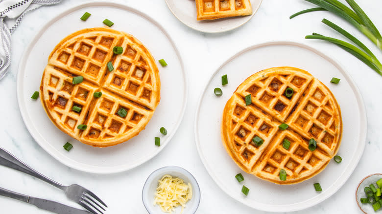 Two plates of bacon cheddar waffles