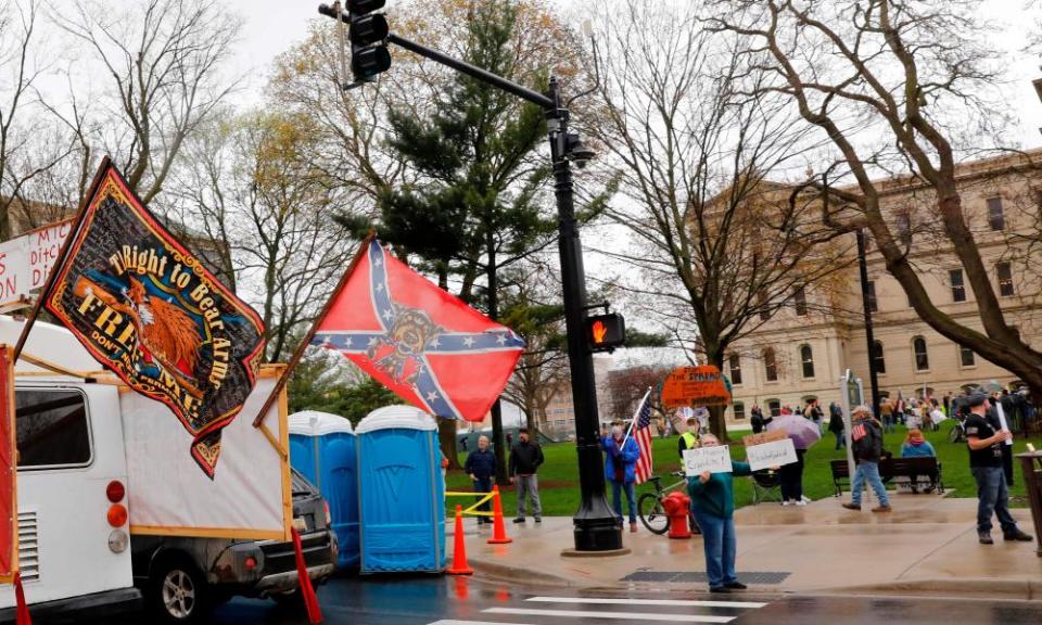 Demonstrators display a Confederate flag at the anti-lockdown protest in Lansing.