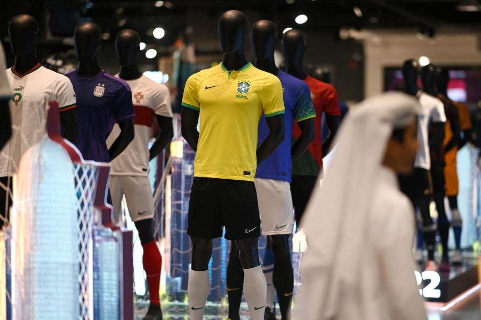 A man walks past a replica of Brazil's national team jersey in a mall in Doha on October 29, 2022, ahead of the Qatar 2022 FIFA World Cup football tournament. (Photo by Gabriel BOUYS / AFP) (Photo by GABRIEL BOUYS/AFP via Getty Images)