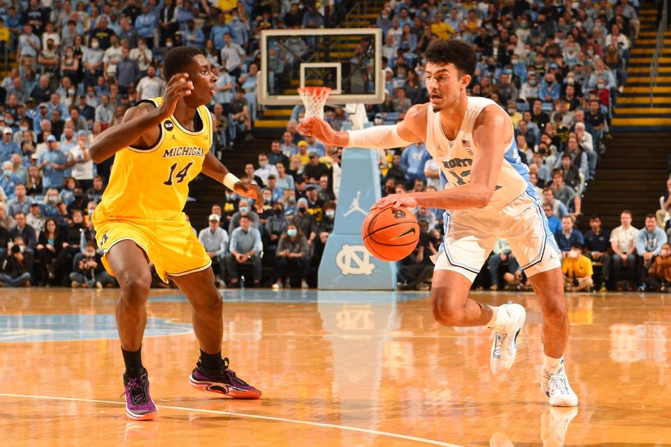 North Carolina forward Dawson Garcia drives on Michigan Wolverines forward Moussa Diabate, left, during the Tar Heels’ win last month.