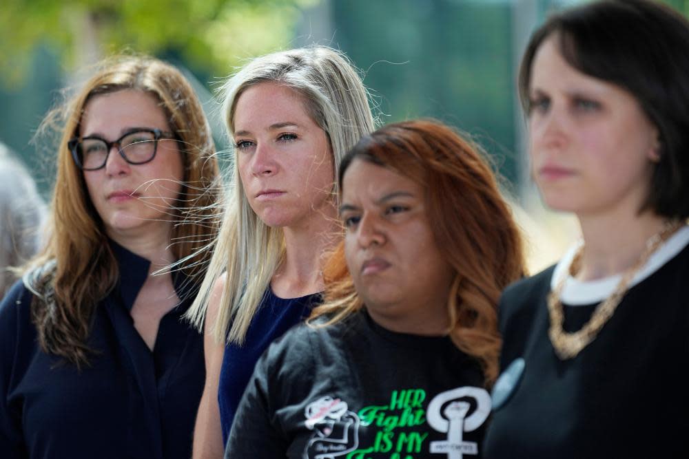 Amanda Zurawski, second from left, who developed sepsis and nearly died after being refused an abortion when her water broke at 18 weeks, and Samantha Casiano, second from right, who was forced to carry a nonviable pregnancy to term and give birth to a baby who died four hours after birth, stand with their attorneys outside the Travis county courthouse, on 19 July 2023, in Austin.
