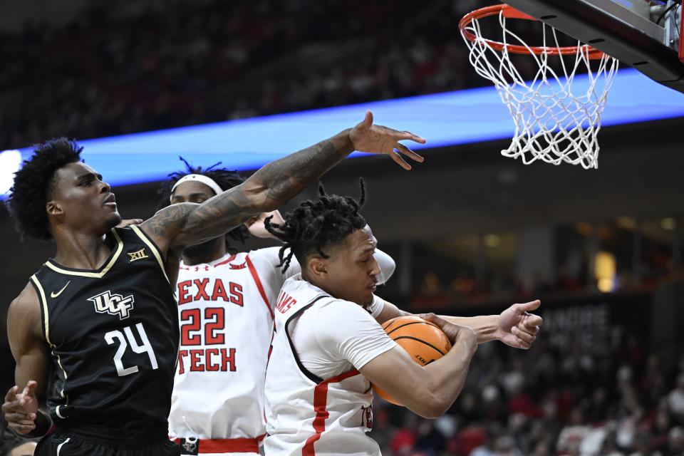 Texas Tech guard Darrion Williams, right, brings down a rebound against Central Florida guard Jaylin Sellers (24) during the second half of an NCAA college basketball game, Saturday, Feb. 10, 2024, in Lubbock, Texas. (AP Photo/Justin Rex)