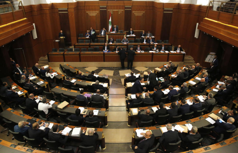 Lebanese lawmakers and ministers meet at the parliament building during the opening session of the draft 2019 state budget, in Beirut, Lebanon, Tuesday, July 16, 2019. Lebanese lawmakers have begun discussing the budget amid tight security and limited protests against proposed austerity measures. The proposed budget aims to avert a financial crisis by raising taxes and cutting public spending in an effort to reduce a ballooning deficit. (AP Photo/Hussein Malla)