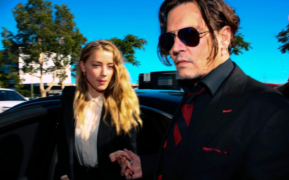 US actor Johnny Depp and his former wife Amber Heard arrive at a court in the Gold Coast in April 2016 - Credit: AFP