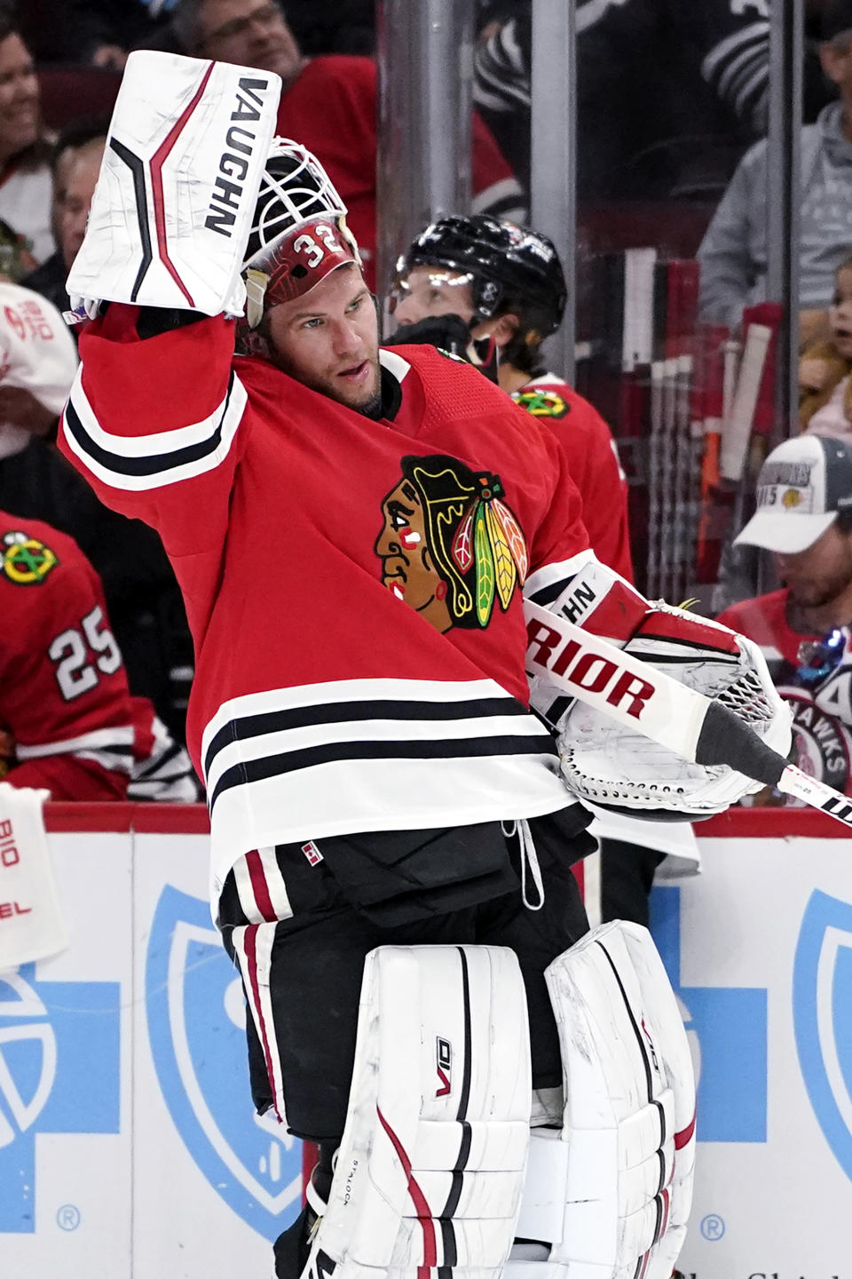 Chicago Blackhawks goaltender Alex Stalock puts on his helmet during the first period of an NHL hockey game against the Seattle Kraken in Chicago, Sunday, Oct. 23, 2022. (AP Photo/Nam Y. Huh)