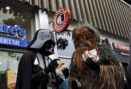 People wearing Star Wars-themed costumes eat pretzels in San Francisco, California July 21, 2015. REUTERS/Robert Galbraith