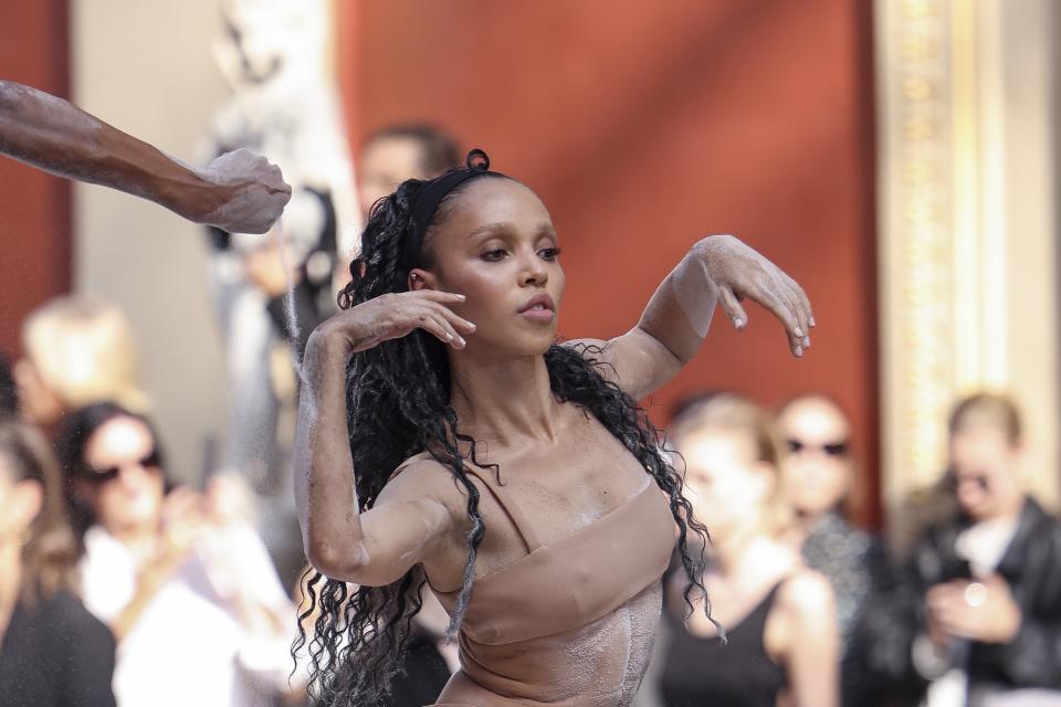 FKA twigs performs during the Valentino Spring/Summer 2024 womenswear fashion collection presented Sunday, Oct. 1, 2023 in Paris. (AP Photo/Vianney Le Caer)