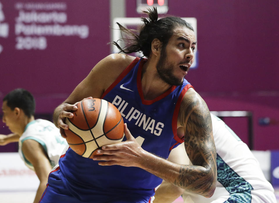 Philippines' Christian Standhardinger drives to the basket during their men's basketball match against Kazakhstan at the 18th Asian Games in Jakarta, Indonesia on Thursday, Aug. 16, 2018. (AP Photo/Aaron Favila)