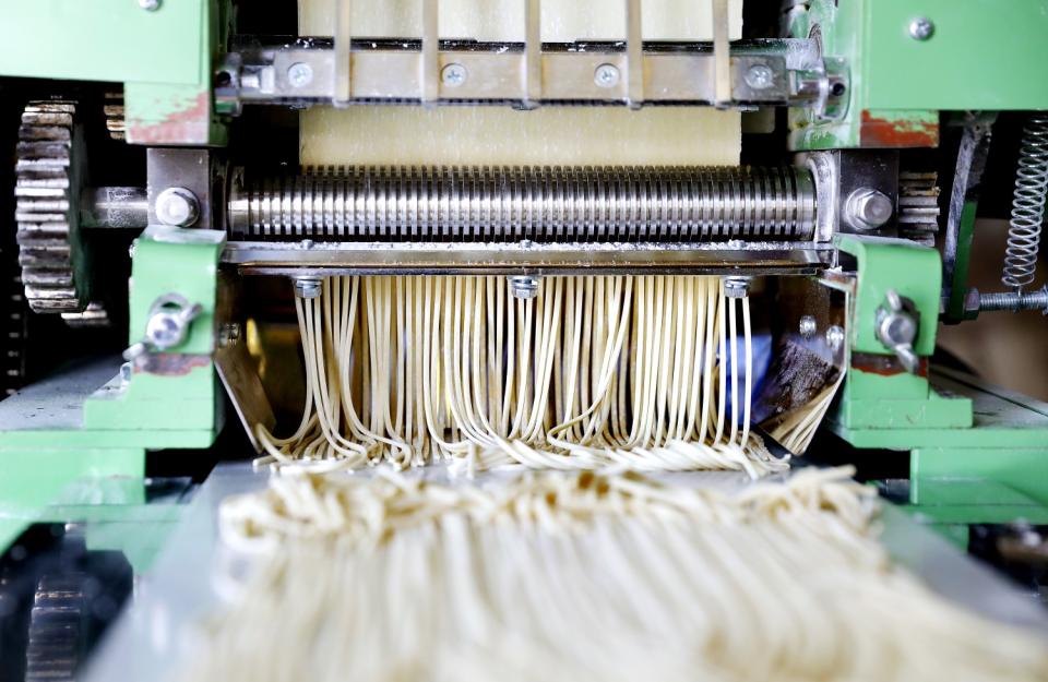 A machine produces noodles