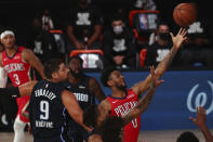 New Orleans Pelicans guard Nickeil Alexander-Walker (0) shoots a layup against Orlando Magic center Nikola Vucevic (9) during the first half of an NBA basketball game Thursday, Aug. 13, 2020, in Lake Buena Vista, Fla. (Kim Klement/Pool Photo via AP)