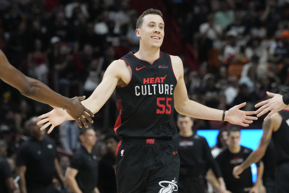 Miami Heat forward Duncan Robinson (55) is congratulated by his teammates after scoring a three-point basket during the first half of an NBA basketball game against the Atlanta Hawks, Friday, Jan. 19, 2024, in Miami. (AP Photo/Marta Lavandier)