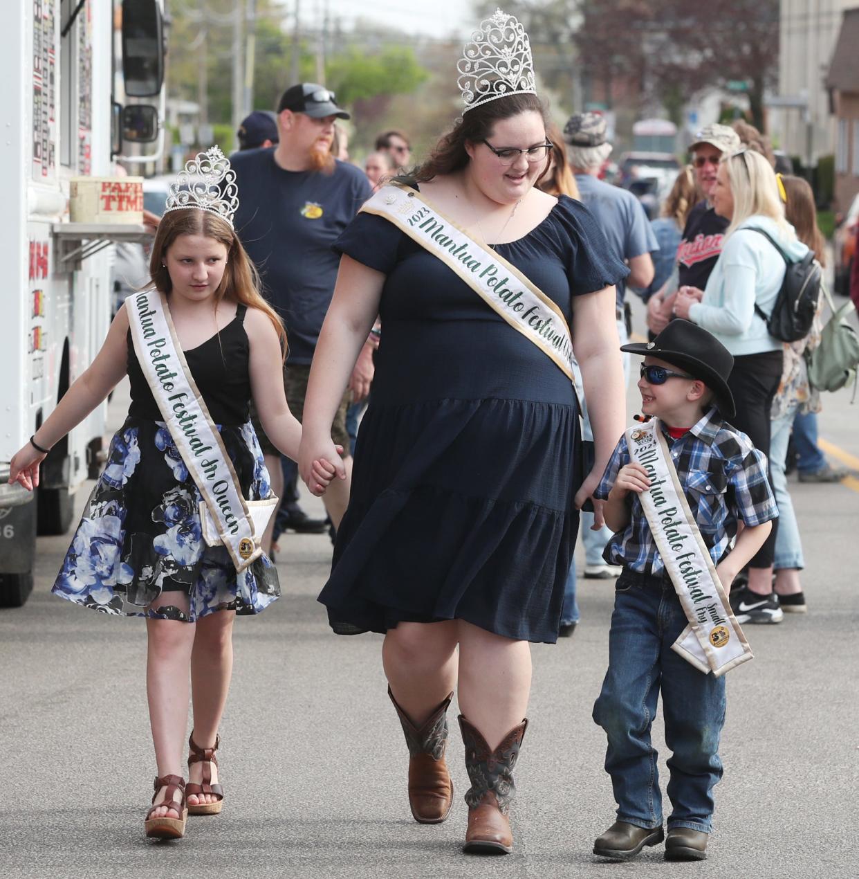 Mackenzie Thompson, 2023 Mantua Potato Festival Queen, center, walks with 2023 Junior Queen Hailey Roosa, left, and 2023 Small Fry Hudson Roosa-Varner as they take in the Ravenna Jo-Jo Festival on Friday.