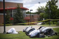 <p>Mohamed Omar, left, the executive director of the Dar Al Farooq Center Islamic Center leads afternoon prayers outside the police tape surrounding the center Saturday Aug. 5, 2017 in Bloomington, Minn. (Photo: Aaron Lavinsky/Star Tribune via AP) </p>