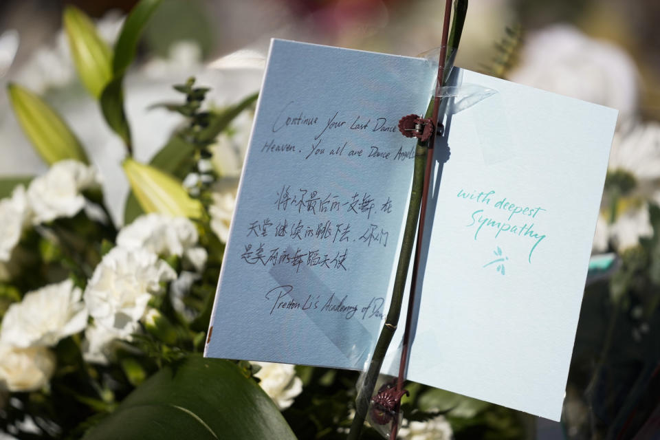 A card and flowers are placed outside the Star Ballroom Dance Studio on Tuesday, Jan. 24, 2023, in Monterey Park, Calif. A gunman killed multiple people at the ballroom dance studio late Saturday amid Lunar New Year's celebrations in the predominantly Asian American community. (AP Photo/Ashley Landis)