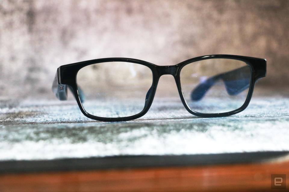 <p>Razer Anzu smart glasses review photo. Slightly left side angled view of the Razer smart glasses sitting on a desk with arms unfolded.</p>
