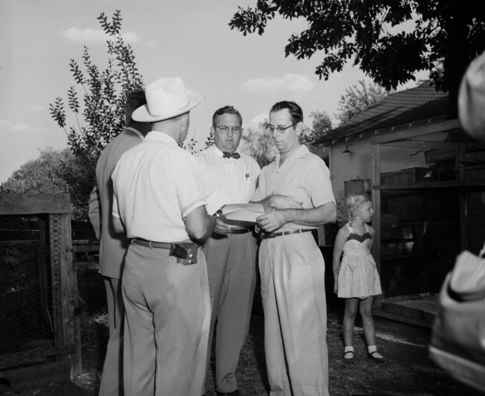 Mowrer Animal Company owner Reo Mowrer, right, speaks with former Springfield Police Department Chief Frank Pike in September 1953.