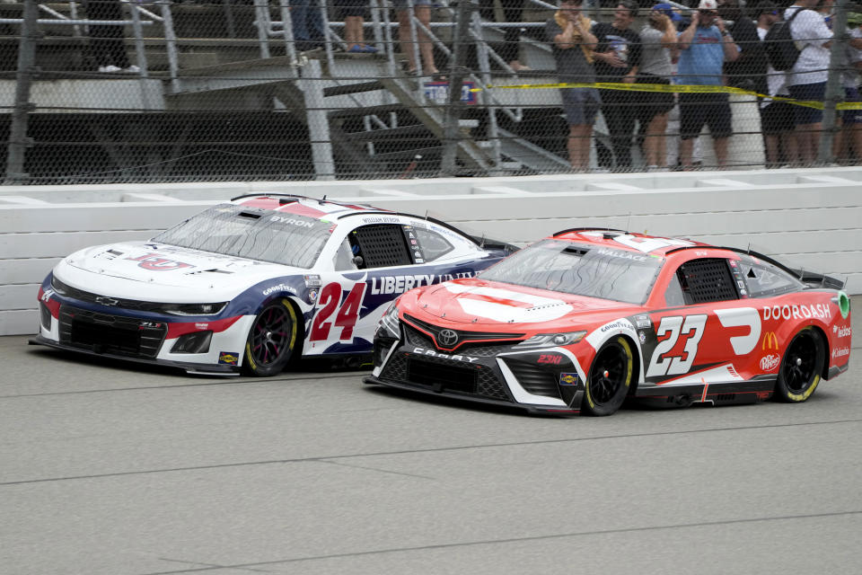 William Byron (24) and Bubba Wallace (23) battle for position during a NASCAR Cup Series auto race at Michigan International Speedway in Brooklyn, Mich., Sunday, Aug. 6, 2023. (AP Photo/Paul Sancya)