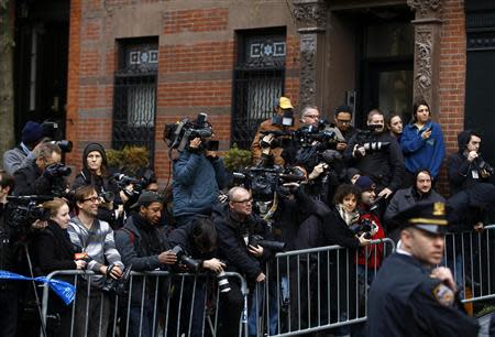 Members of the media stand outside the apartment of movie actor Philip Seymour Hoffman after he was found dead in New York February 2, 2014. REUTERS/Joshua Lott